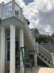 A multi-level exterior staircase featuring white railings, installed by Fencing & Railing 2 Corp in Orlando, FL.