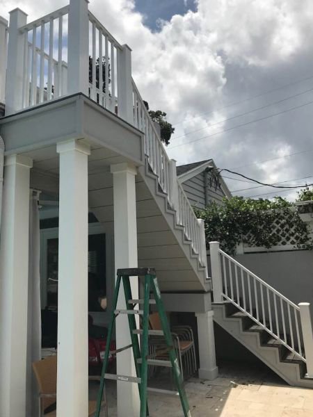 A multi-level exterior staircase featuring white railings, installed by Fencing & Railing 2 Corp in Orlando, FL.