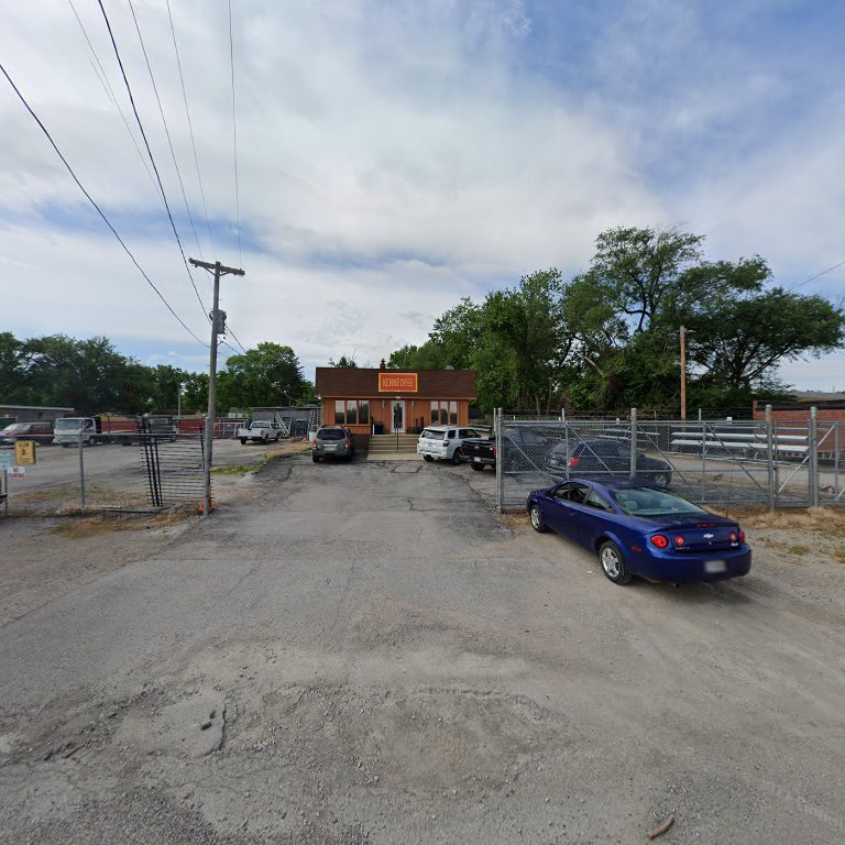 Exterior view of the Kennedy Fence Corporation building and fenced yard in St. Louis, MO, showcasing their services.
