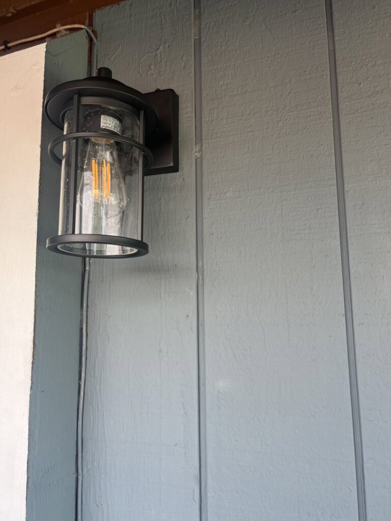 An exterior wall light fixture installed on a house by Andrew's Electric in Kent, WA
