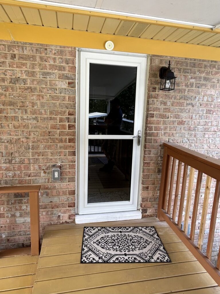 An exterior wall light fixture installed next to a door by C. C. Taylor Electric LLC in Powhatan, VA.