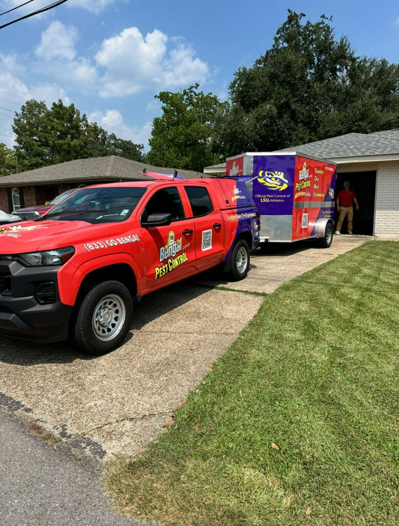 A BengalPro Exterminators truck and trailer parked at a residential property for a pest control job in Baton Rouge, LA.