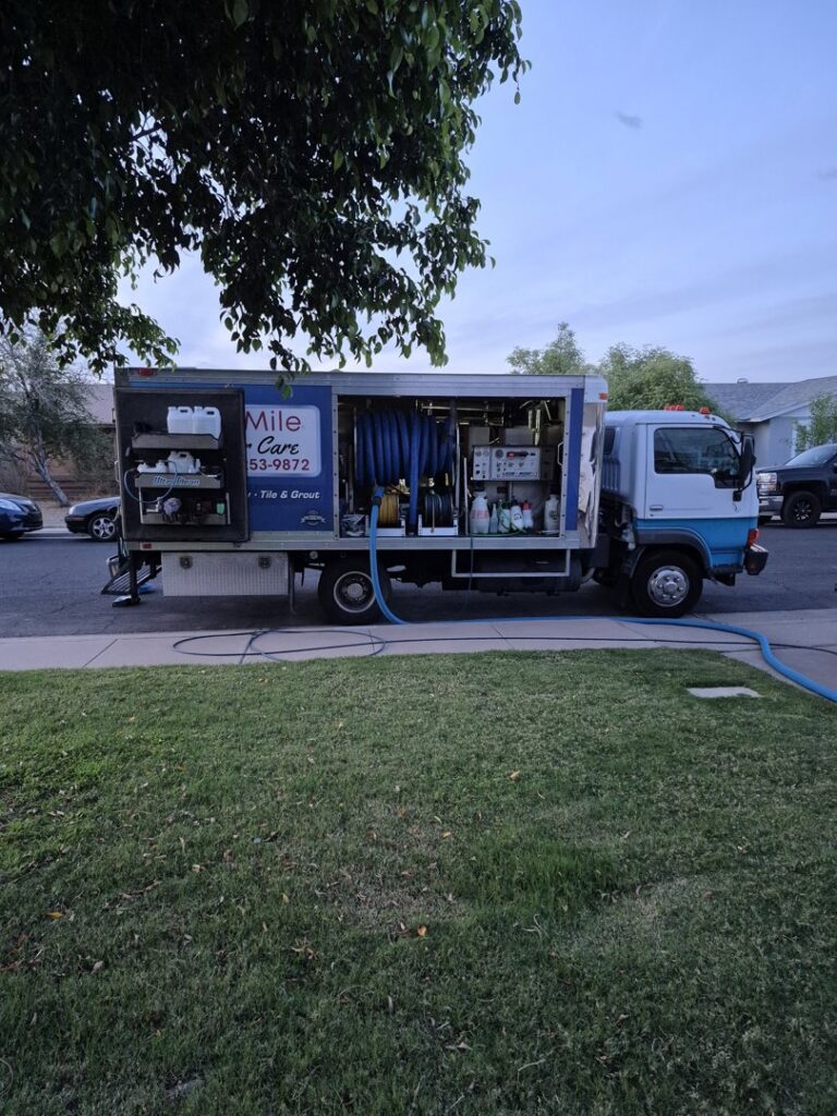 The Extra Mile Floor Care service truck parked on-site with hoses extended, ready for a carpet cleaning job in Mesa, AZ.