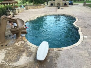 A family enjoying a sparkling clean swimming pool, maintained by Alabama Pool Kings in Madison, AL.