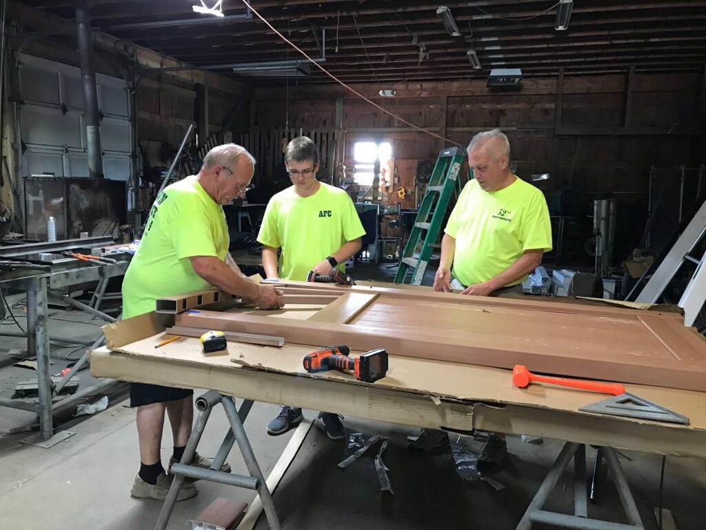 Austintown Fence contractors assembling fence panels in their workshop in Youngstown, OH.