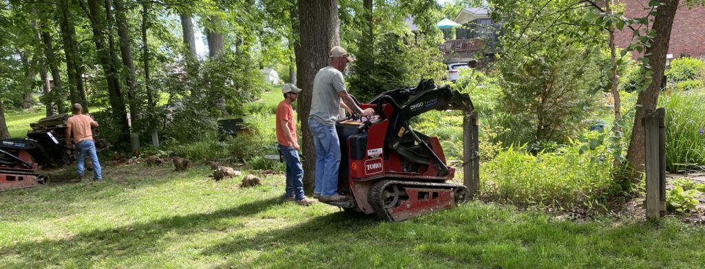 A crew from Raatz Fence Company installing fence posts with machinery in Louisville, KY.