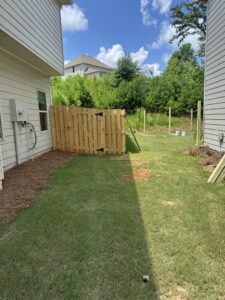 Fence post installation in progress for a new wood fence by Right Now Fencing, LLC in Johns Creek, GA