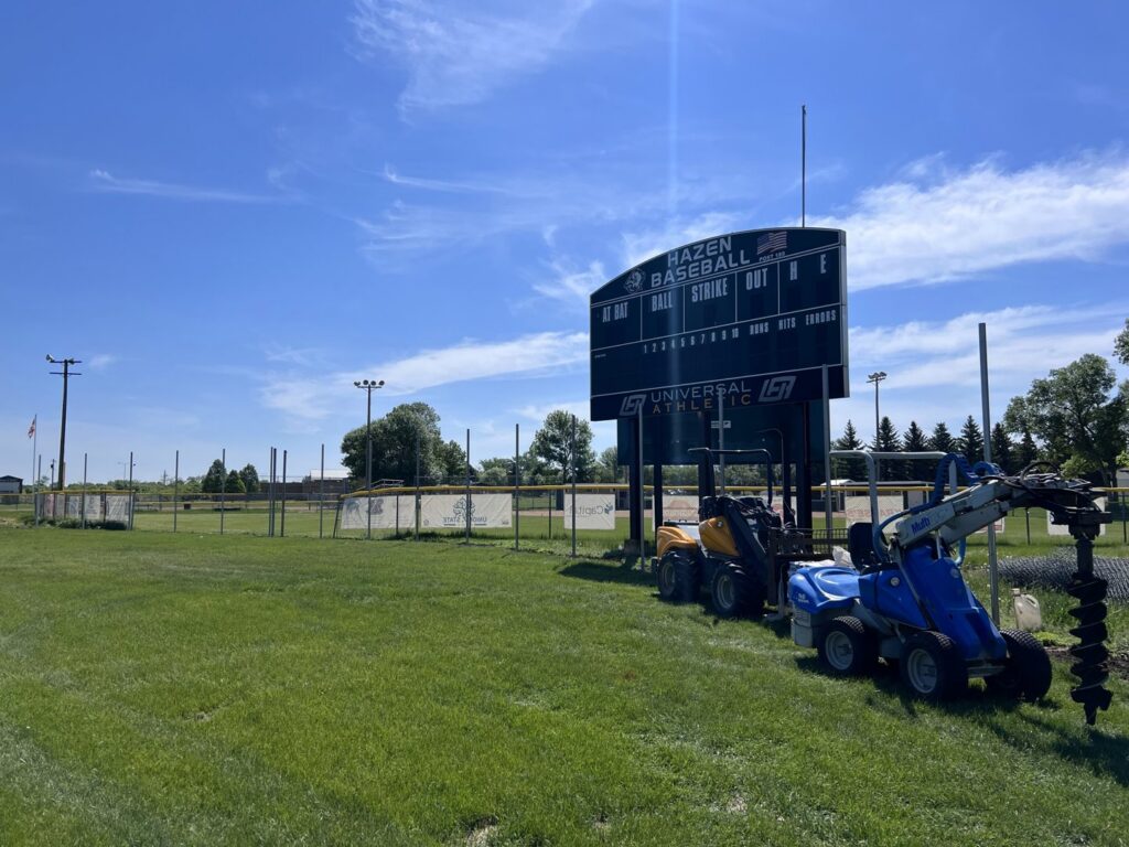 Fencing equipment, including a post hole digger, at a baseball field for Western Fence in Hebron, ND.