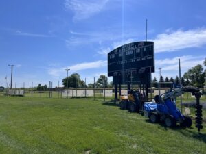 Fencing equipment, including a post hole digger, at a baseball field for Western Fence in Hebron, ND.