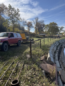 Fencing equipment, truck, and trailer at a job site by Deer Creek Ag Services in Ranchester, WY.