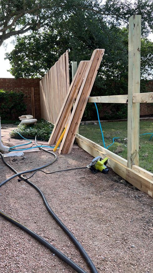 A wooden fence installation in progress with posts, rails, and pickets by Alexi's Handyman Services in Indianapolis, IN.