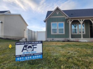 A quality fencing job completed by All Over Fence Idaho, with a promotional sign in the foreground in Jerome, ID