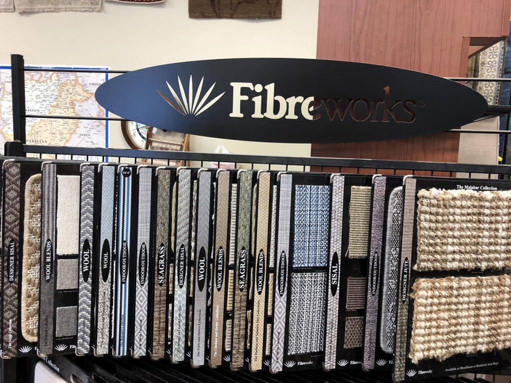 A display of Fibreworx carpet and rug samples in the showroom at Rug Masters in Charleston, SC.