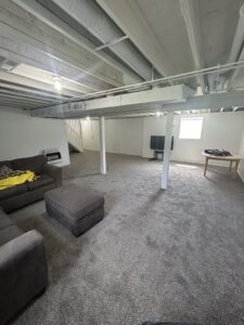 Another view of a finished basement with gray carpet installed by Wilkins Floorcovering in Livonia, MI