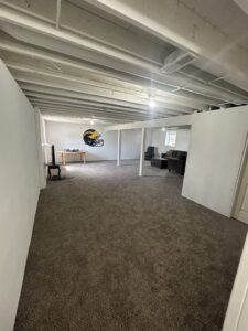 A spacious finished basement featuring new gray carpet installed by Wilkins Floorcovering in Livonia, MI