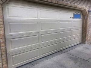 A finished beige garage door installation on a residential home by ETS - Garage Door & Electric Gate Repair Of Bellevue, WA.