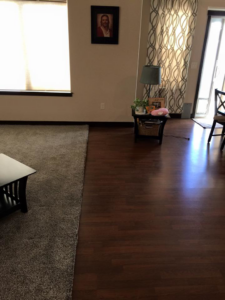 A neatly finished carpet edge next to hardwood flooring, showcasing work by Essential Carpet Repair in Salt Lake City, UT.