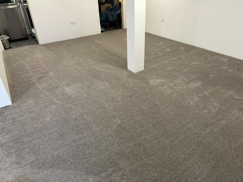 Another view of a room with recently installed grey carpet by Creative Carpet Solutions LLC, a carpet contractor in Houston, TX.