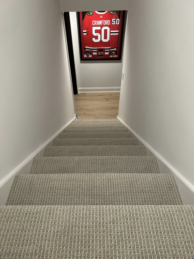 View of a completed carpet installation on a residential staircase by Creative Carpet Solutions LLC in Houston, TX.