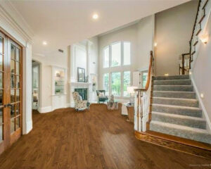 A beautifully finished staircase with carpeted treads by Lazos Flooring Service, a carpet contractor in Plano, TX.