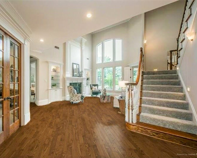 A beautifully finished staircase with carpeted treads by Lazos Flooring Service, a carpet contractor in Plano, TX.