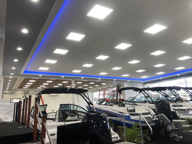 A finished commercial showroom with bright ceiling lights and blue accent lighting installed by RTF Electric LLC in Toms River, NJ.