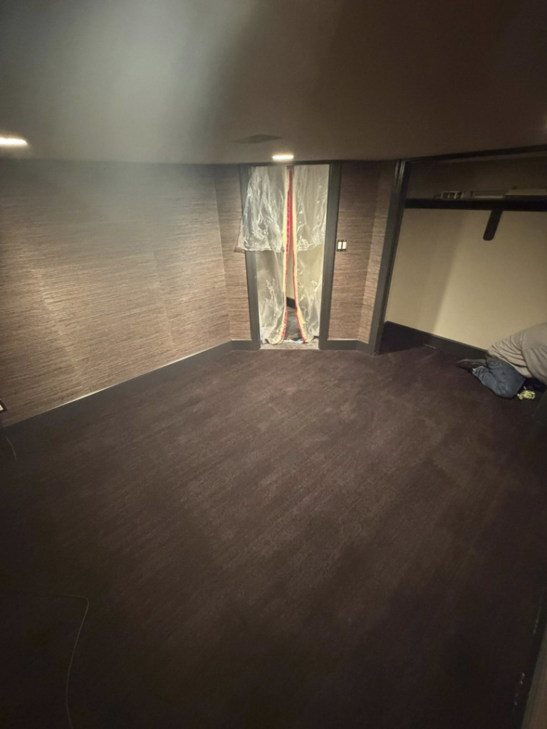 A finished dark carpet installation in a room by Good Guy Flooring, your carpet contractor in Kansas City, MO