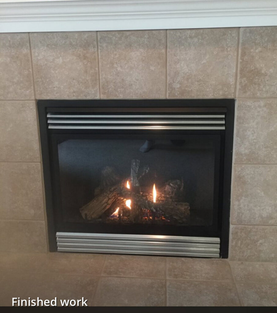 A newly installed gas fireplace with active flames, labeled 'Finished work' by Precision Energy LLC in Everett, WA.