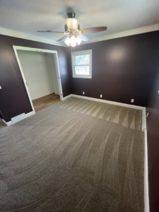 A finished grey carpet installation in a bedroom by CDK Flooring, LLC in Sheboygan, WI.