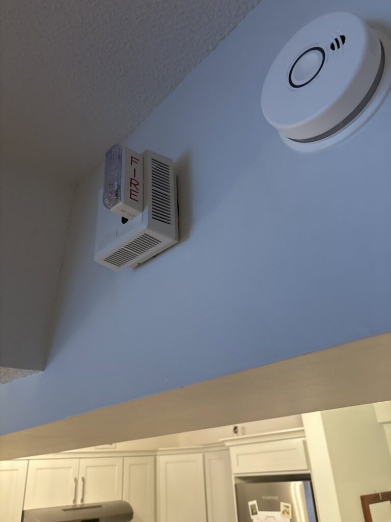 A fire alarm strobe and smoke detector installed by Electric Hero in Boston, MA