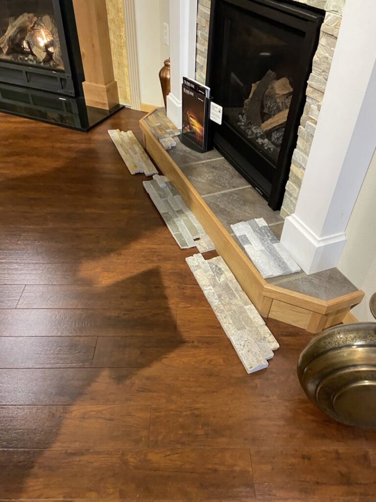 Fireplace hearth with tile samples, showing customization options from Wood Stoves For Sale in Fairbanks, AK.