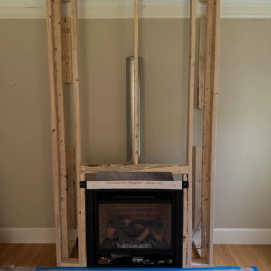 Greer Enterprises installing a new fireplace insert and flue system in Raymond, NH.
