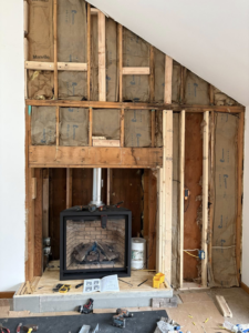 A fireplace insert installation in progress within a framed chimney structure by Cozy Hearth Chimney in South Avington Township, PA.