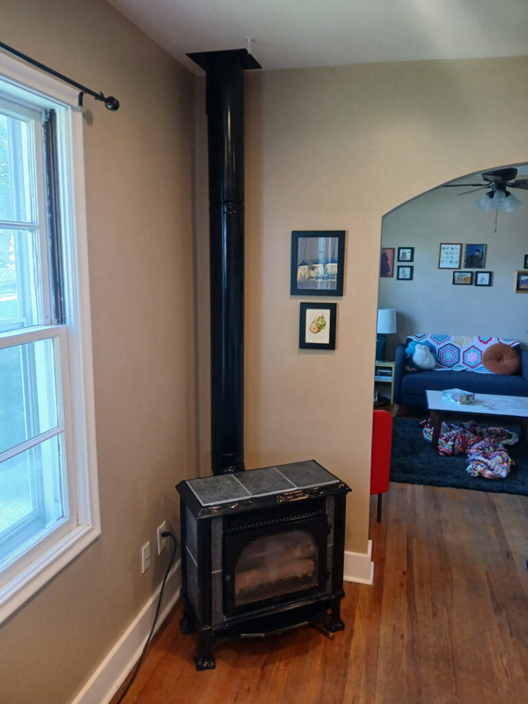 A newly installed fireplace stove with a flue pipe by Utah Mechanical Heating and Air Conditioning in South Ogden, UT.