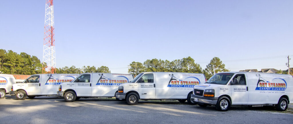 A fleet of Get Steamed Carpet Cleaning, Inc. vans parked, ready for service in North Charleston, SC.