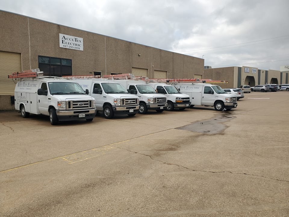 A fleet of white service vans for AccuTex Electric, ready for electrician jobs in Fort Worth, TX.