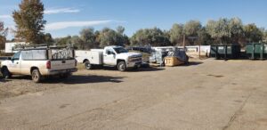 Front Range Raynor Garage Door & Service fleet of service trucks and materials in their Fort Collins, CO, yard.