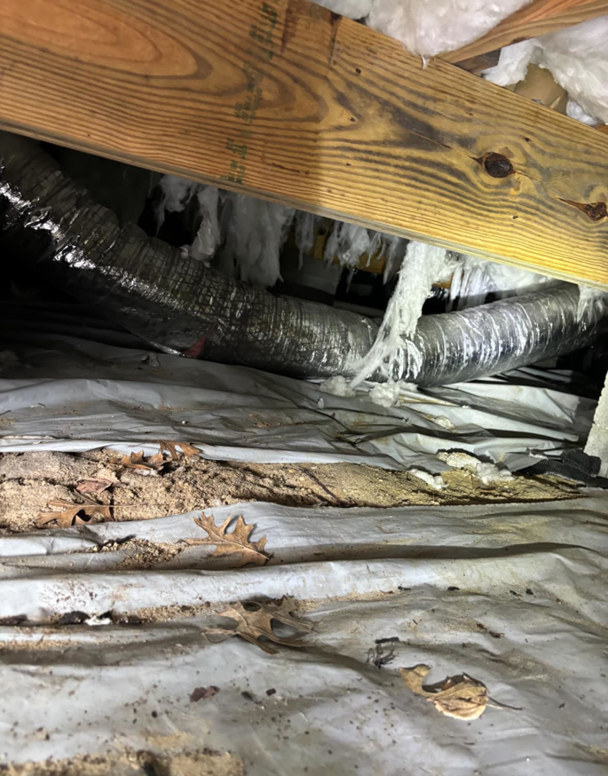 Flexible HVAC ductwork running through a crawl space by Greene Mechanical in Holly Springs, GA.