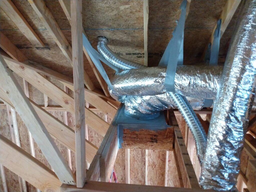 Flexible HVAC ductwork installed in an unfinished attic space by Dowd Heat & Air in Tulsa, OK.