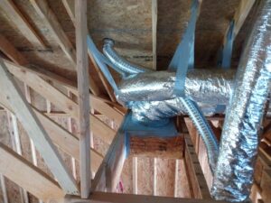 Flexible HVAC ductwork installed in an unfinished attic space by Dowd Heat & Air in Tulsa, OK.