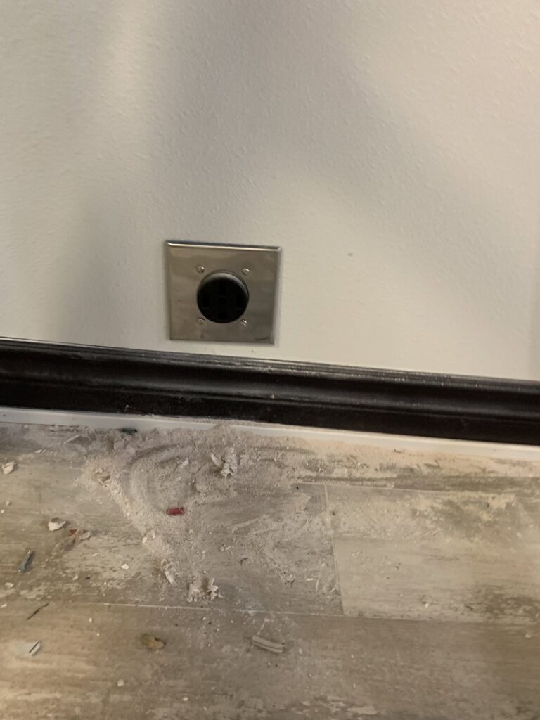 A metal floor electrical or data port installed by Your Electrician in Yakima, WA.