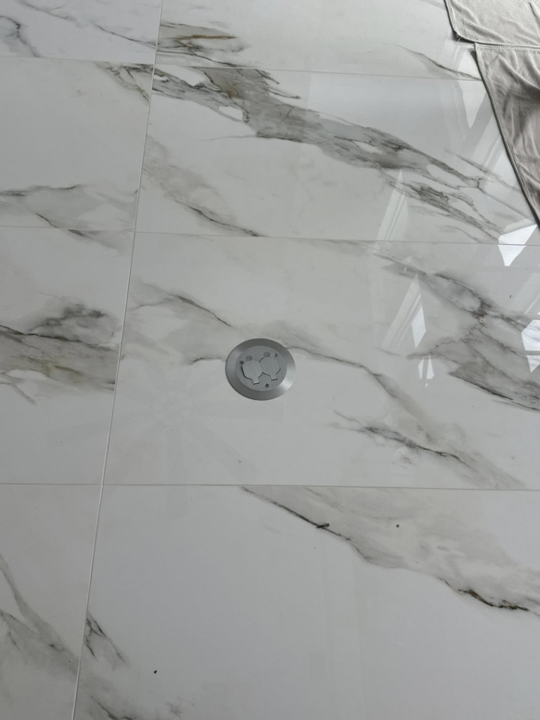 Floor electrical outlet installation on a tiled floor by LMV Electric LLC in Houston, TX