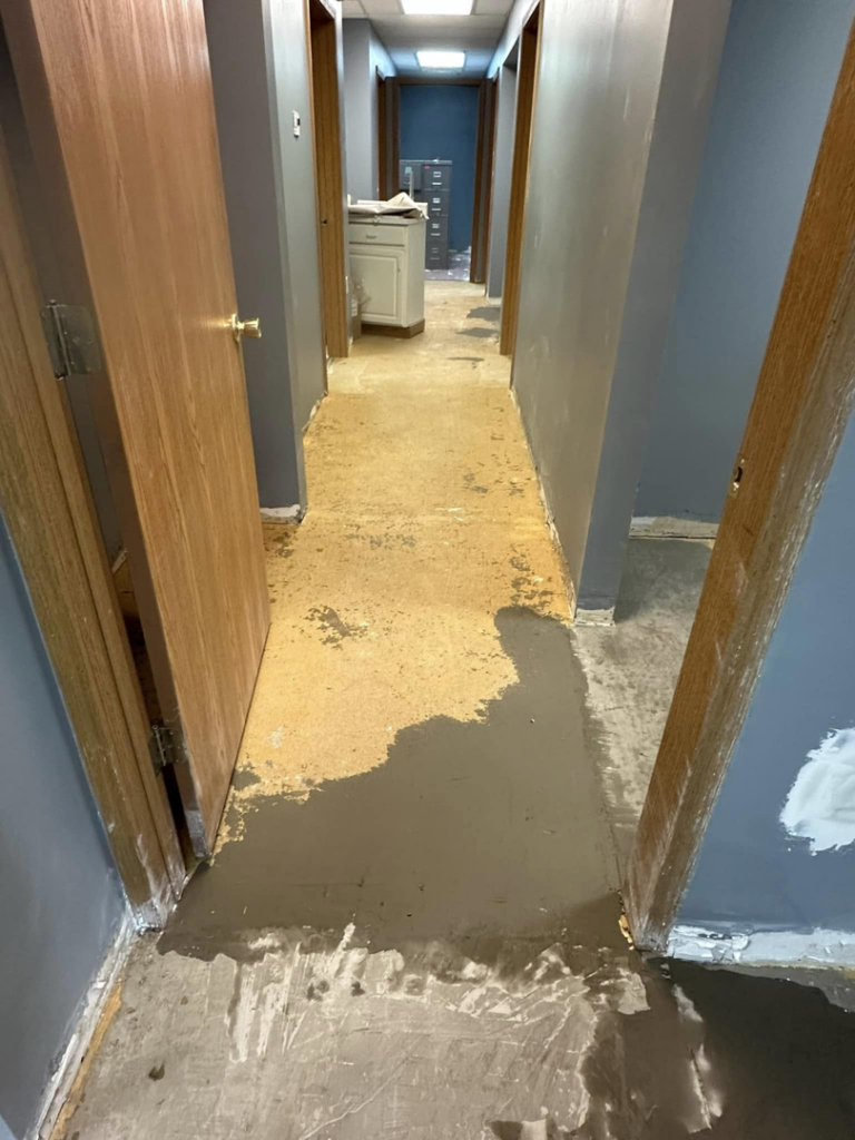 Floor leveling and preparation for carpet installation in a hallway by Long's Family Flooring Solutions LLC in New Alexandria, PA.