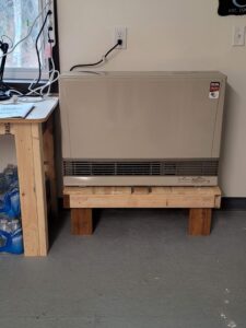 A floor-standing heating unit, typical of HVAC systems serviced by HeatSource Mechanical in Wasilla, AK.
