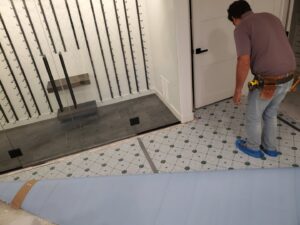 A professional installer working on a new flooring installation project for Carpet One Floor & Home Denver in Denver, CO.