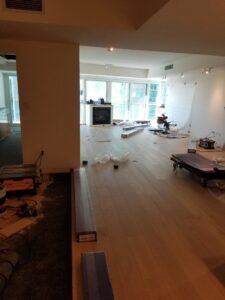 A room undergoing flooring installation, with tools and materials covered in plastic, by LACarpetWarehouse in Los Angeles, CA.