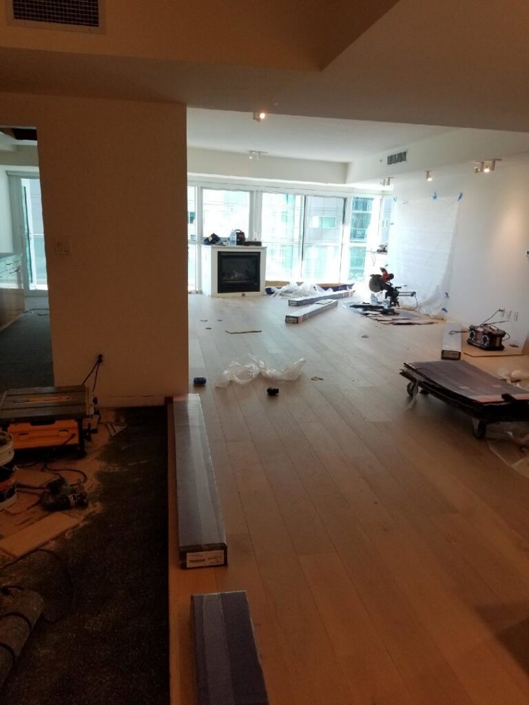 A room undergoing flooring installation, with tools and materials covered in plastic, by LACarpetWarehouse in Los Angeles, CA.