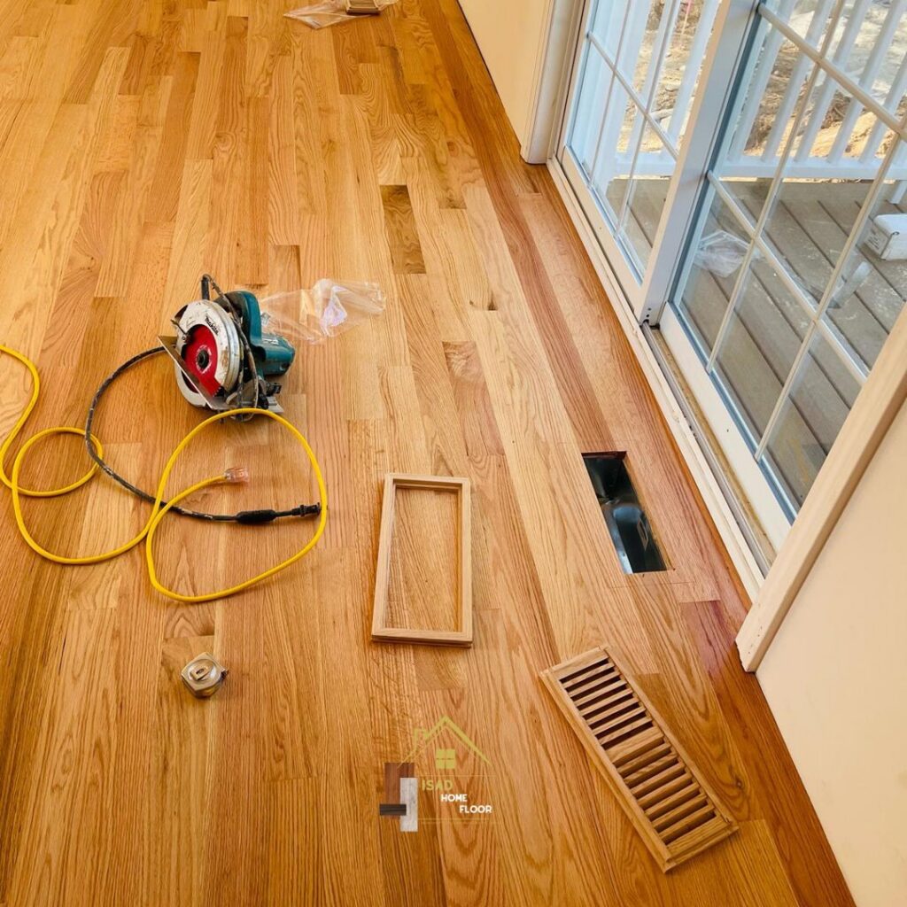 Flooring installation tools, including a circular saw, on a newly laid hardwood floor by Isad Home Floor in Bridgeport, CT.