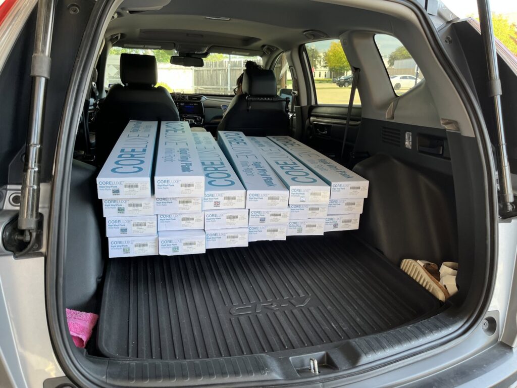 Boxes of CORELUXE Rigid Vinyl Plank flooring loaded in an SUV for delivery by Carpet and Flooring Liquidators - Dallas in Arlington, TX.