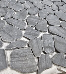 Various flooring product displays, including wood and tile samples, inside the Bronco Carpets and Flooring showroom in Caldwell, ID.